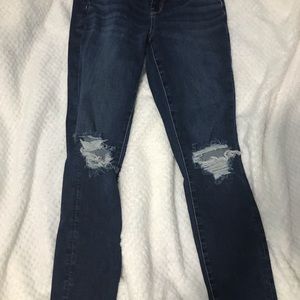 American eagle skinny jeans with rips at the knees.